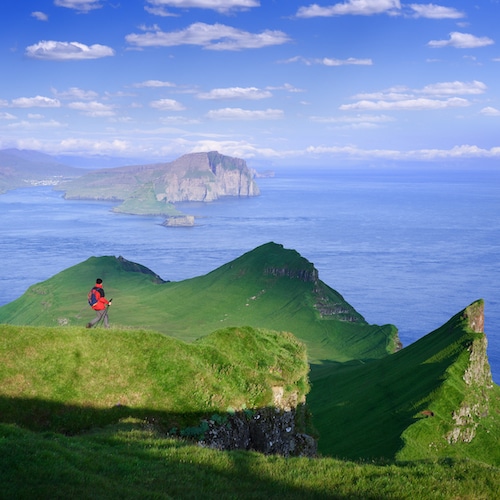 Hiking on Mykines Island overlooking the Vagar and Tindholmur, Faroe Islands