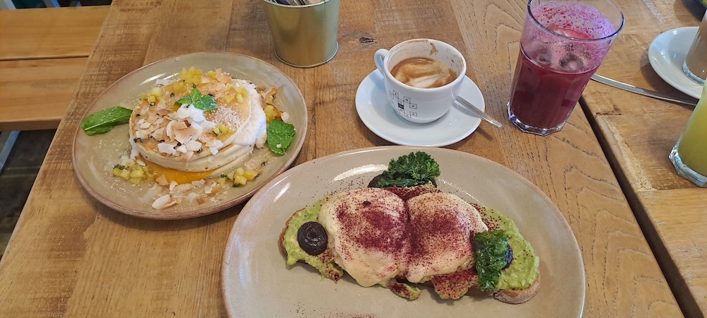 pancakes, avocado toast with eggs and capuccino at fauna and flore in estoril